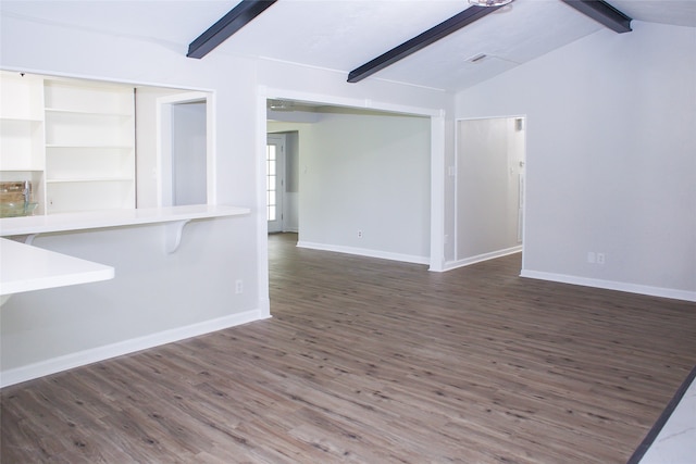 unfurnished living room featuring lofted ceiling with beams and dark wood-type flooring