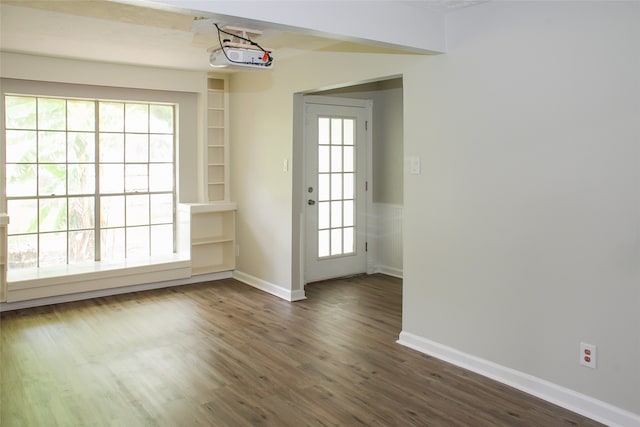 unfurnished dining area with a healthy amount of sunlight and dark hardwood / wood-style flooring