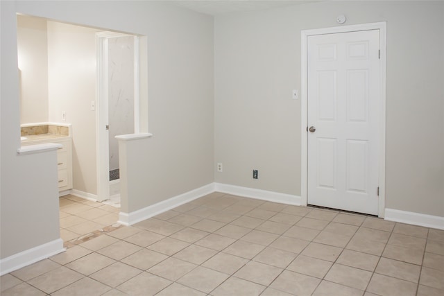 spare room featuring light tile floors