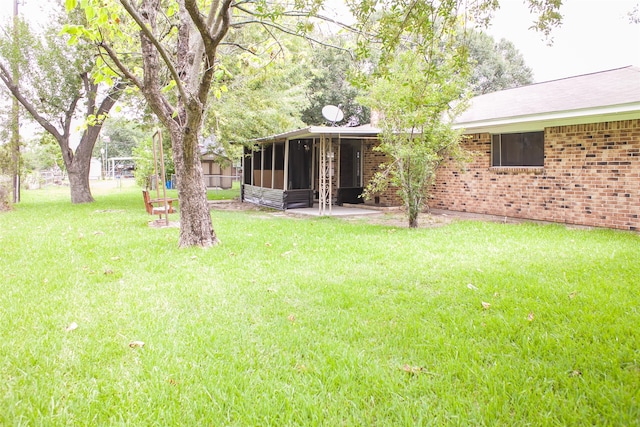 view of yard with a patio and a sunroom