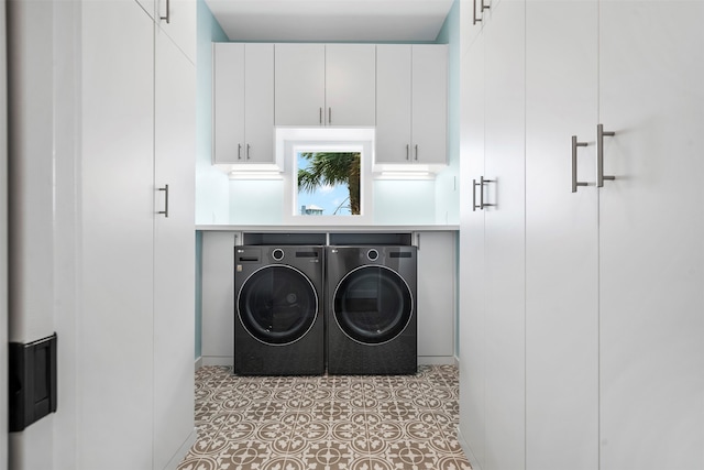 clothes washing area with washing machine and dryer