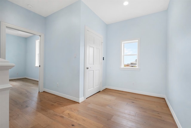 interior space with light wood-type flooring, a healthy amount of sunlight, and baseboards