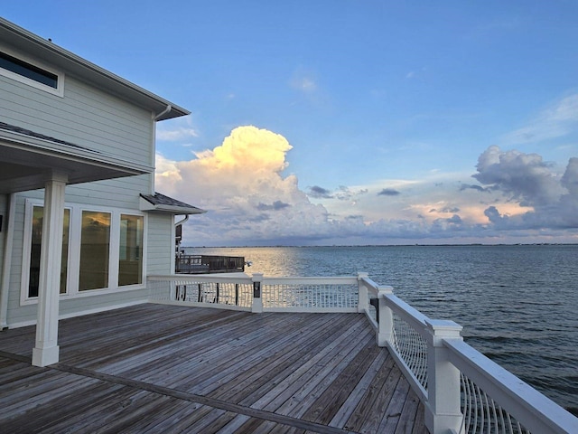 exterior space featuring a deck with water view