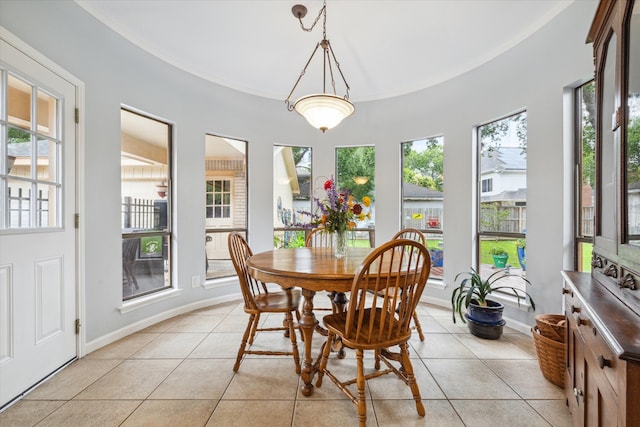 tiled dining area featuring plenty of natural light and ornamental molding