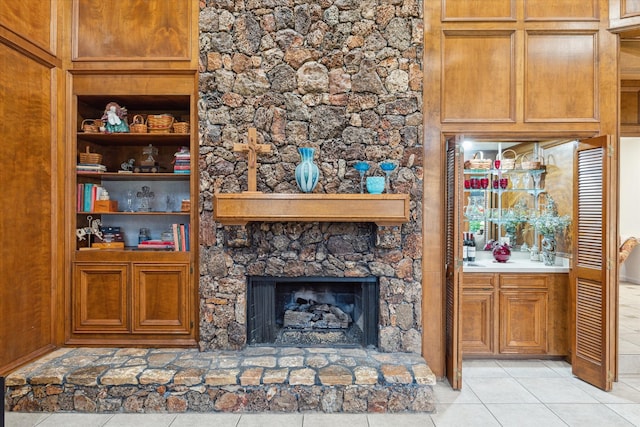 unfurnished living room featuring light tile flooring and a fireplace