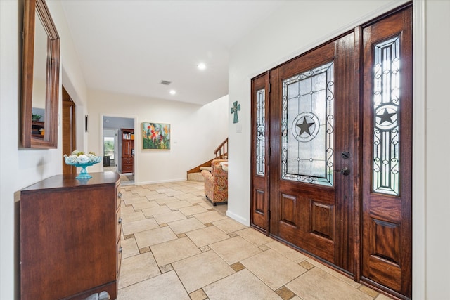 foyer featuring plenty of natural light and light tile floors