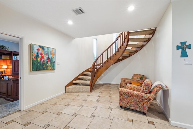 staircase with light tile floors