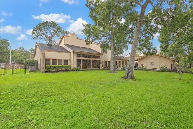 rear view of house with a yard