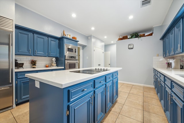 kitchen with built in appliances, tasteful backsplash, and blue cabinets