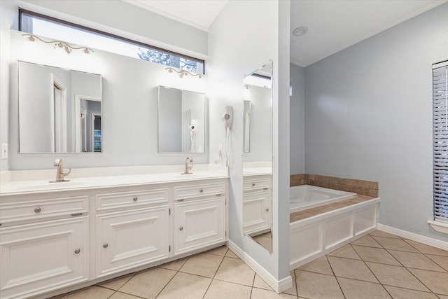 bathroom with a washtub, dual vanity, and tile floors