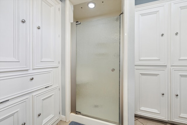 bathroom featuring tile flooring and walk in shower