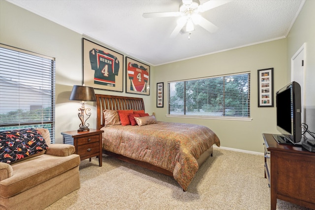 bedroom featuring crown molding, ceiling fan, carpet floors, and a textured ceiling