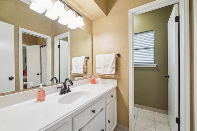 bathroom featuring tile flooring and large vanity