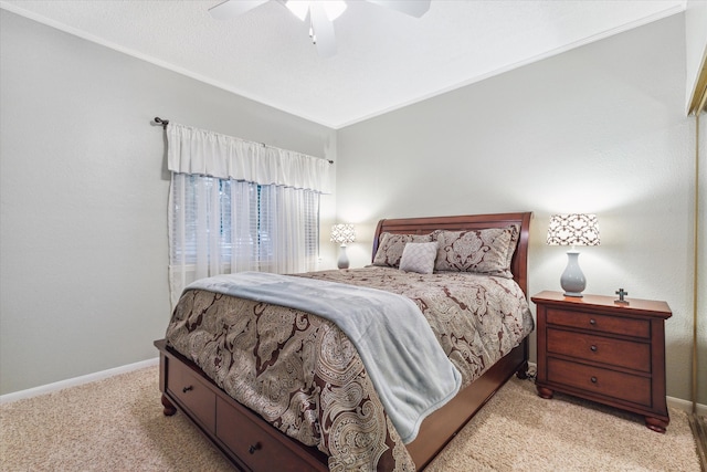 carpeted bedroom featuring ornamental molding and ceiling fan