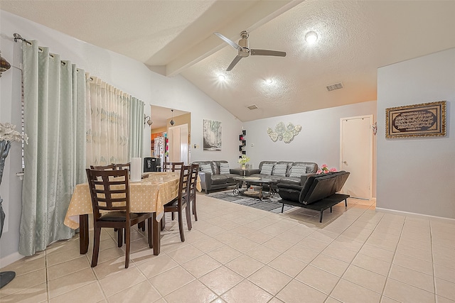 tiled dining room with ceiling fan, lofted ceiling with beams, and a textured ceiling