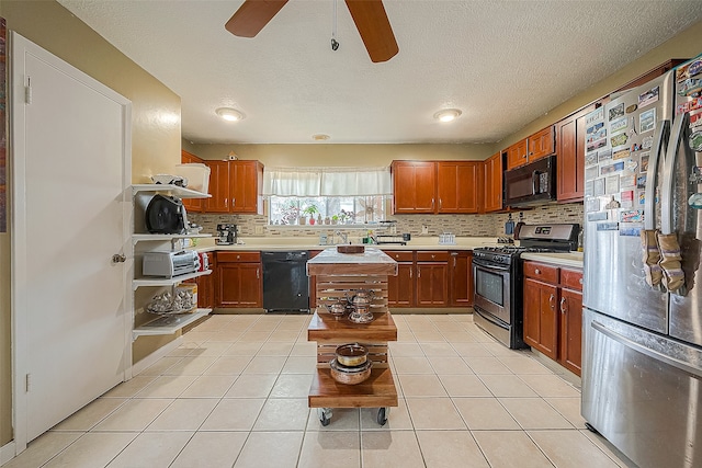 kitchen featuring light tile floors, black appliances, ceiling fan, and a center island