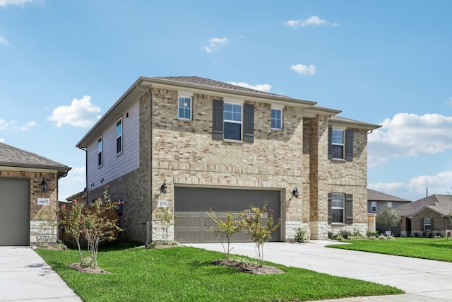 view of front facade featuring a front yard and a garage