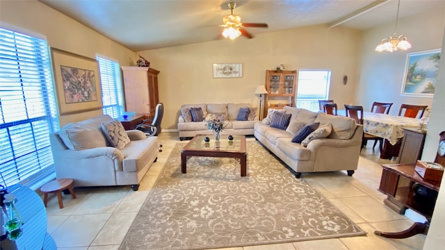 tiled living room featuring ceiling fan with notable chandelier and vaulted ceiling