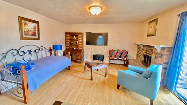 bedroom with a fireplace and hardwood / wood-style floors