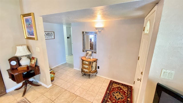 hallway featuring light tile floors