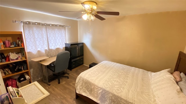 bedroom with ceiling fan and hardwood / wood-style flooring