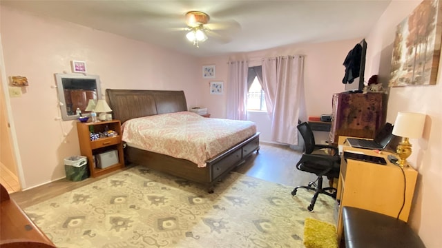 bedroom with ceiling fan and hardwood / wood-style flooring