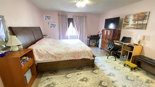 bedroom with ceiling fan and hardwood / wood-style flooring