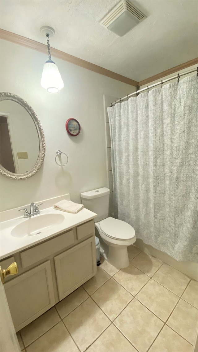 bathroom with tile floors, crown molding, toilet, and vanity