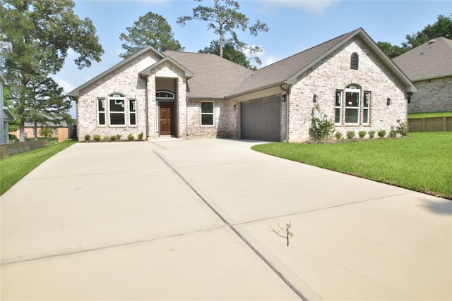 view of front of property with a garage and a front lawn