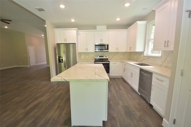 kitchen featuring a center island, dark hardwood / wood-style flooring, white cabinetry, and appliances with stainless steel finishes