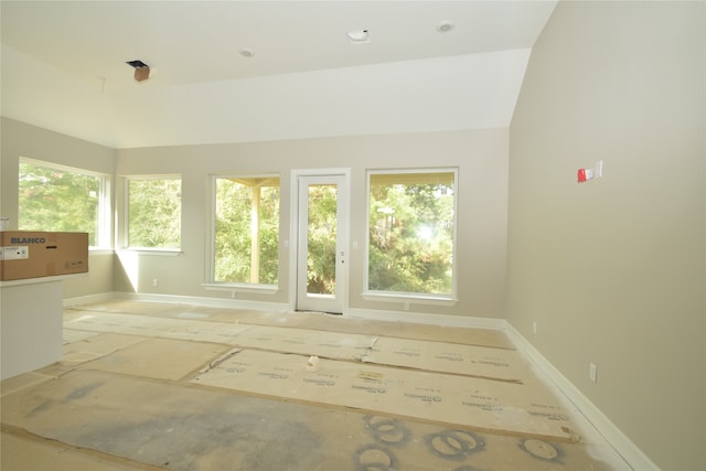 interior space featuring vaulted ceiling and plenty of natural light