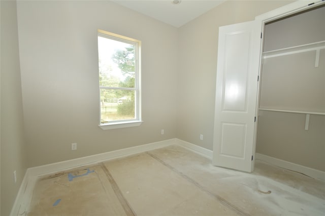 unfurnished bedroom featuring a closet and lofted ceiling