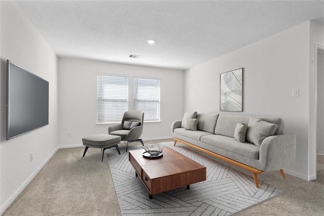 carpeted living room with a textured ceiling