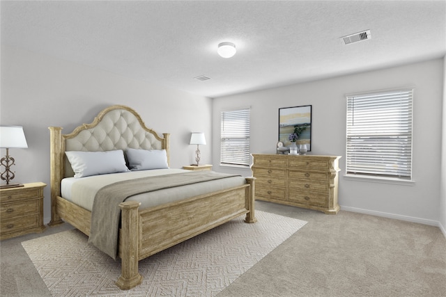 carpeted bedroom featuring a textured ceiling