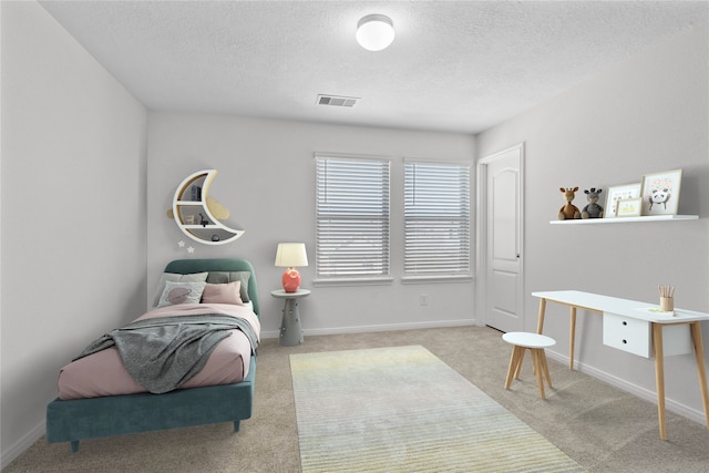 carpeted bedroom with a textured ceiling