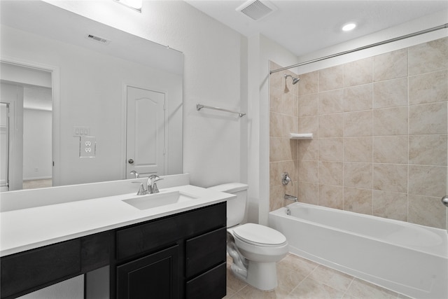 full bathroom featuring toilet, vanity, tiled shower / bath combo, and tile patterned floors