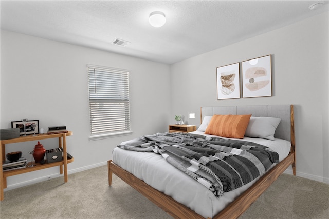 carpeted bedroom featuring a textured ceiling