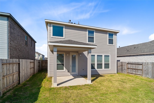 back of house featuring a lawn and a patio area