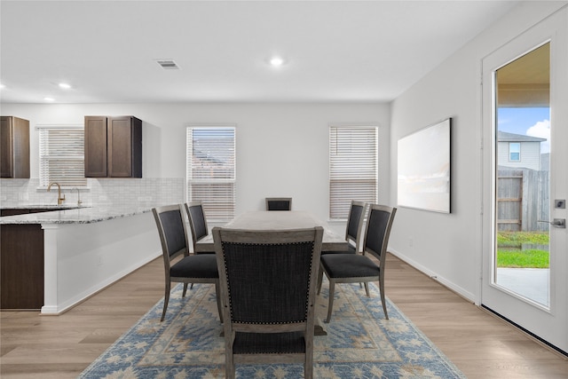 dining room featuring light wood-type flooring and sink