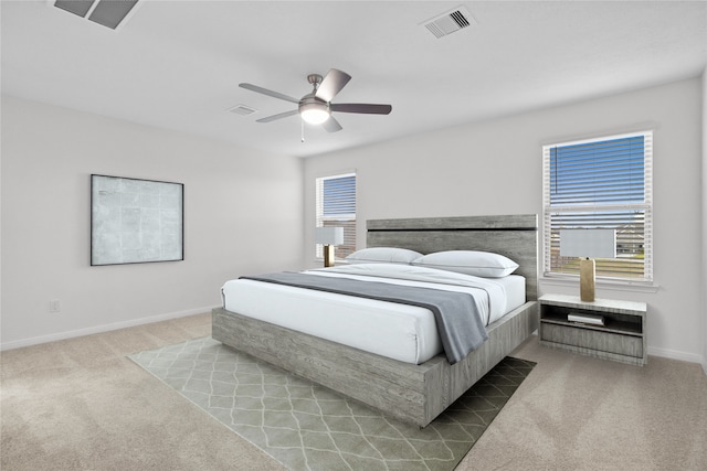 bedroom featuring light colored carpet and ceiling fan