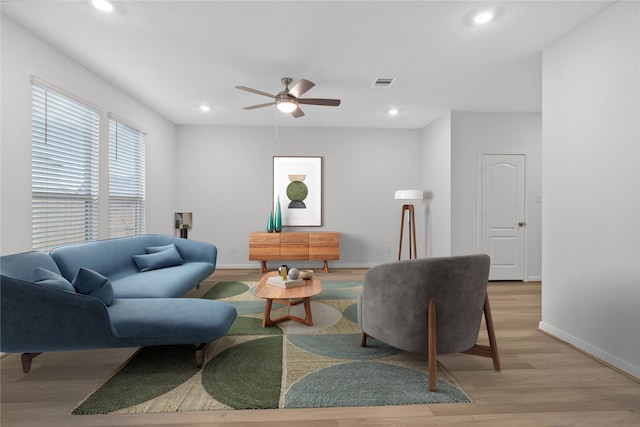 living room with ceiling fan and light hardwood / wood-style floors