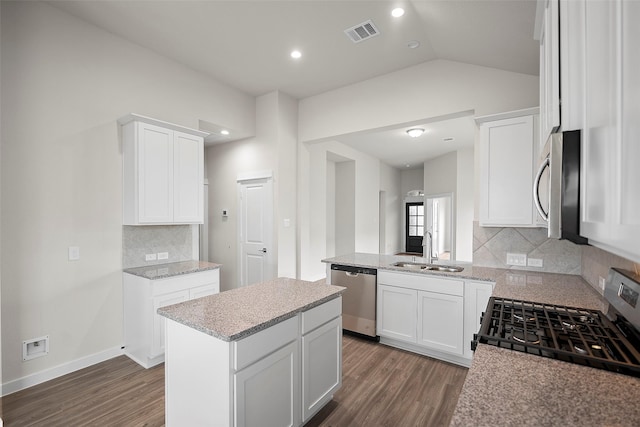 kitchen with a kitchen island, sink, white cabinetry, and stainless steel appliances