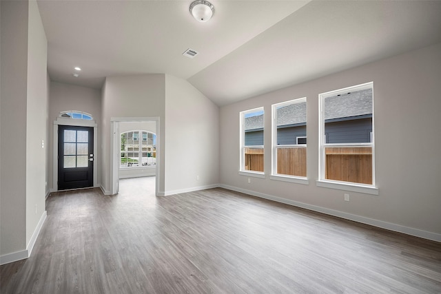 interior space with hardwood / wood-style floors and vaulted ceiling