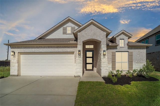 view of front facade with a garage and a yard