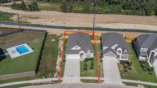 birds eye view of property with a water view