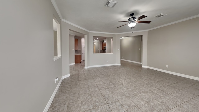 spare room with ornamental molding, ceiling fan, and light tile flooring