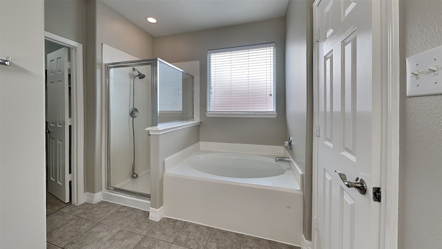 bathroom featuring tile floors and plus walk in shower