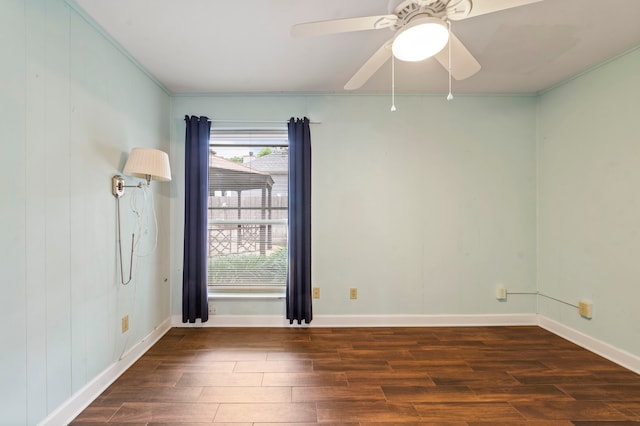 spare room with plenty of natural light, ceiling fan, crown molding, and wood-type flooring