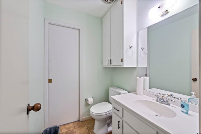 bathroom featuring tile flooring, toilet, and large vanity