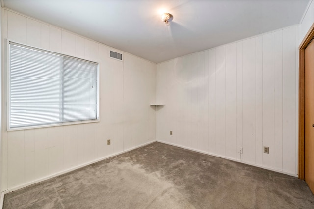 empty room with dark carpet